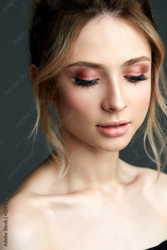 Beautiful young woman with fresh flowers in her hair looking down. Spring concept Beautiful young woman with fresh flowers in her hair looking down. Spring concept