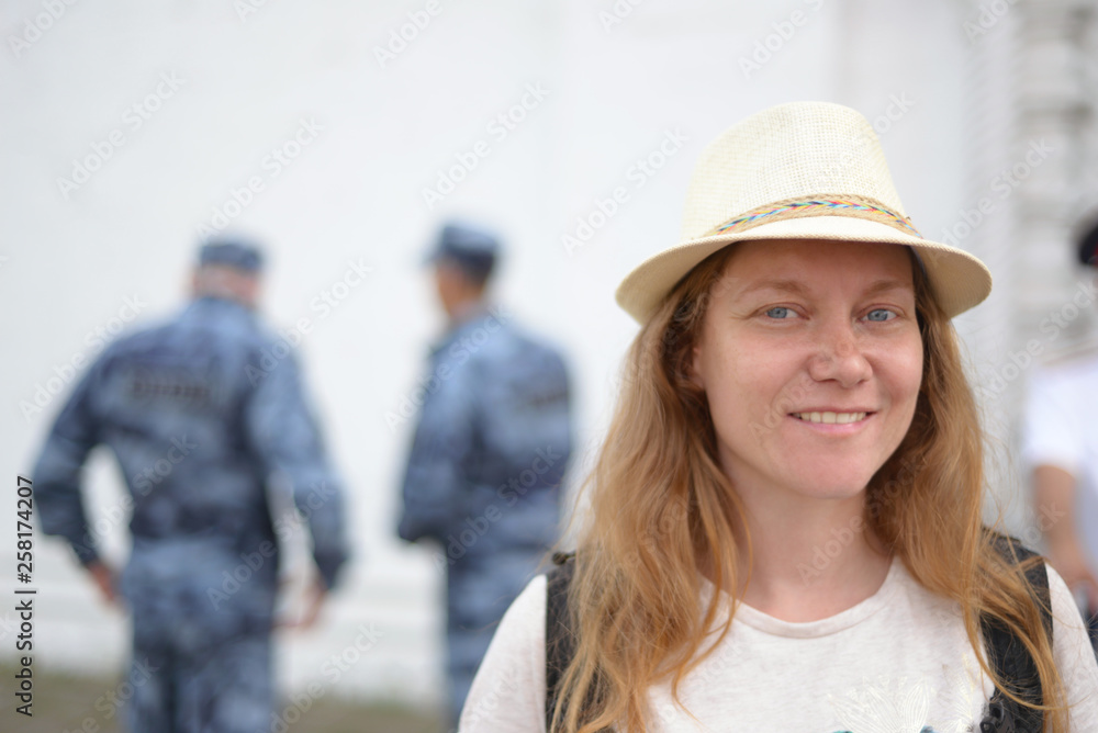 life and safety: happy woman smiling on the background of the guard life and safety: happy woman smiling on the background of the guard