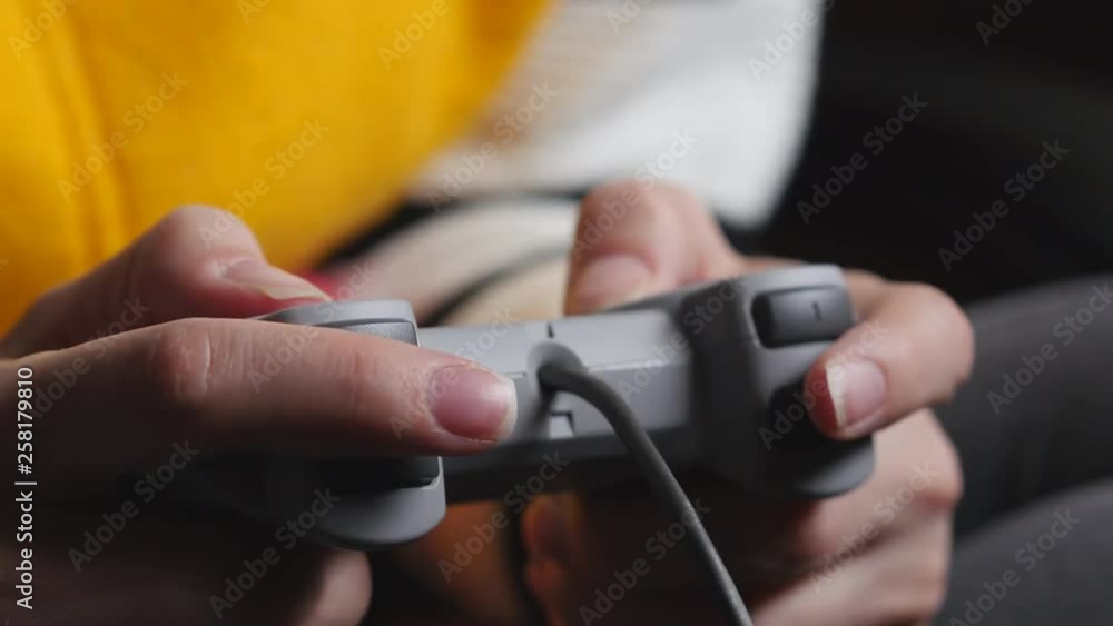 An Female Hands Uses A Game Controller. An Female Hands Uses A Game Controller.