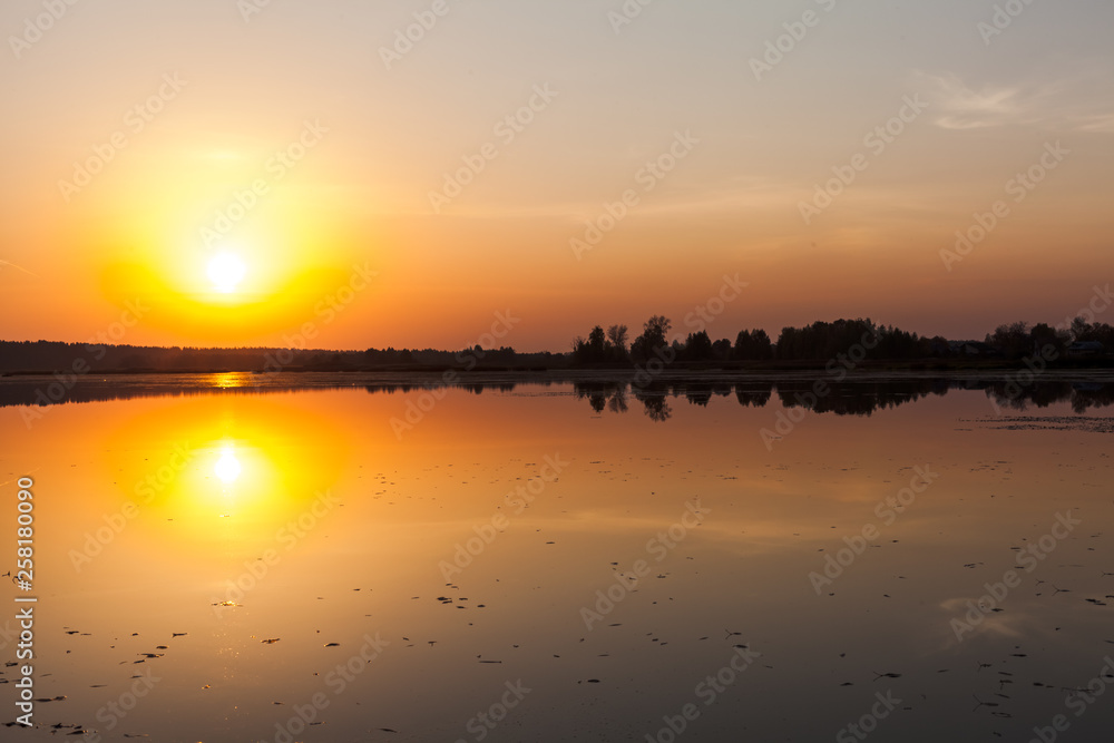 Amazing sunset over the lake. Colorful reflection in the water. Amazing sunset over the lake. Colorful reflection in the water.