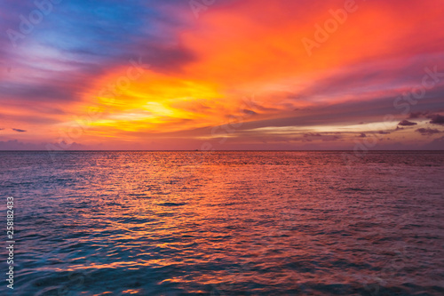 Amazing sunset over the ocean. Colorful reflection in the water.