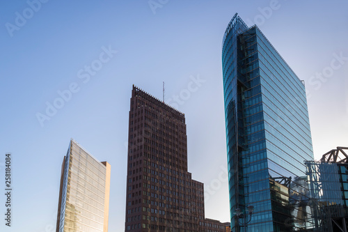 Modern high-rise buildings against clear blue sky at Potsdamer Platz in downtown Berlin, Germany, on a sunny day.