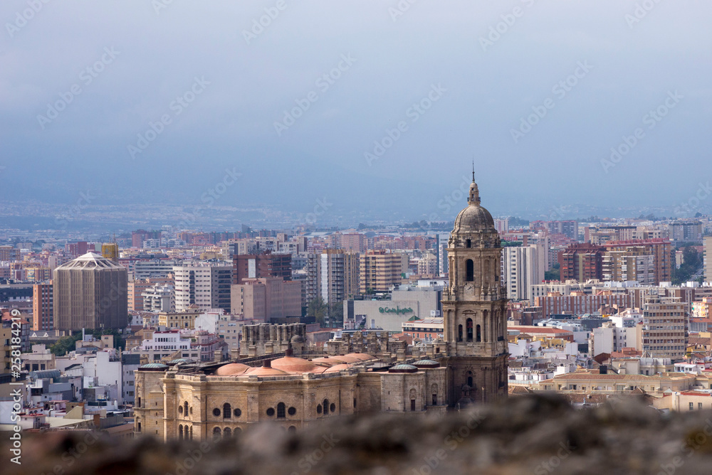 Malaga, Spain, February 2019. Panorama of the Spanish city of Malaga. Cathedral of Malaga. Buildings against a cloudy sky. Dramatic sky over the city. Beautiful view.