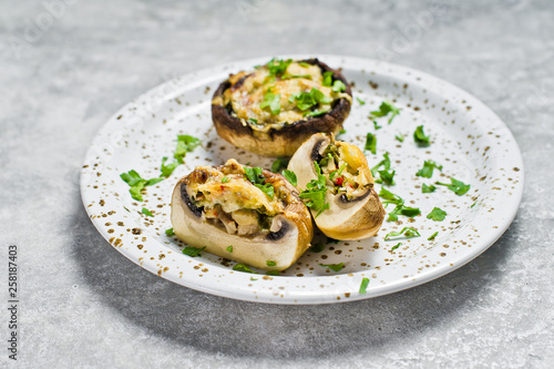 Baked stuffed mushrooms. Gray background, top view, space for text