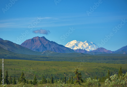 With its huge mountains and surrounded by a wonderful biodiversity lies the Denali National Park and Preserve. Touristic route and cloud sky. Landscape  fine art. Parks Hwy  Alaska  EUA  July 28  2018