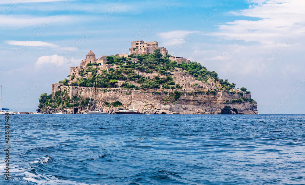 close-up of the island of Ischia Ponte and its castle photographed from the sea