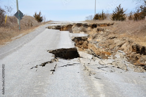 A road is destroyed by erosion caused by spring runoff.