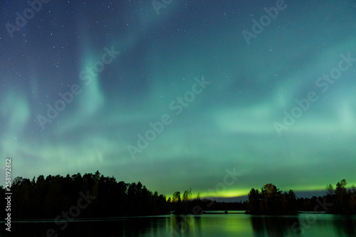 Beautiful northern lights over lake © Juhku