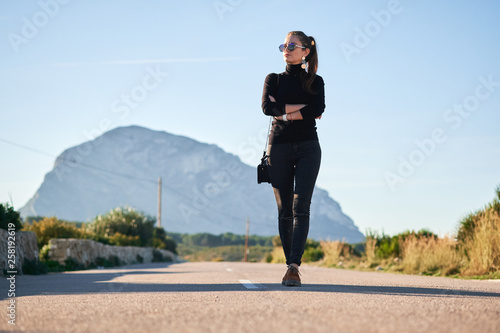 Young woman going on the road against beautiful view