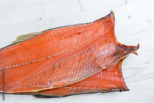 carcass of Cold smoked pink salmon on a wooden background photo