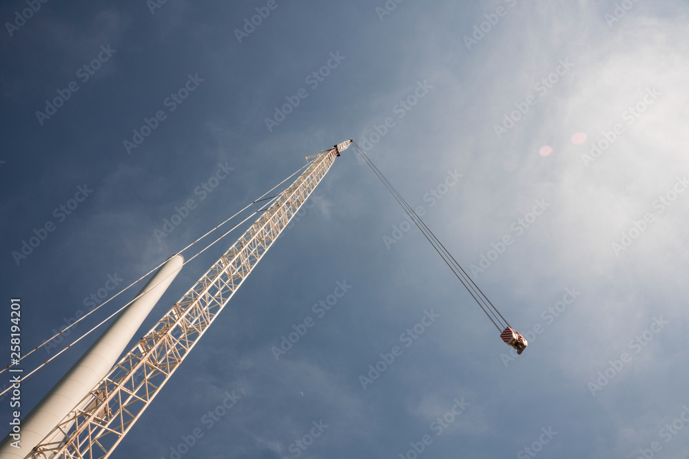 Building and assembling a construction windmill by a crane, The Netherlands. Blue sky Building and assembling a construction windmill by a crane, The Netherlands. Blue sky
