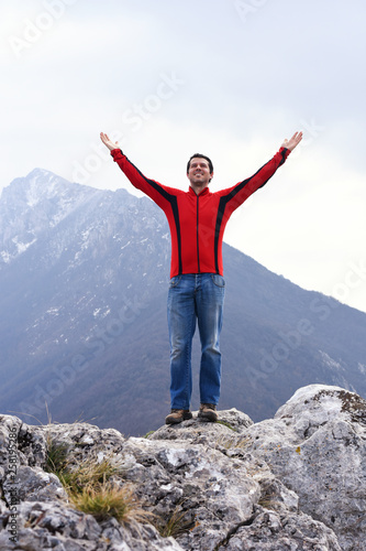 Man rise a hands on top of the mountain. Concept of freedom, man on wild nature in mountains