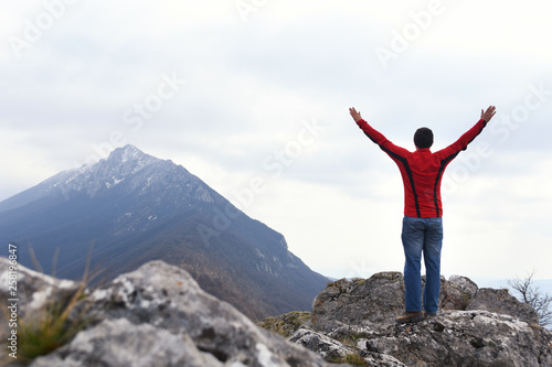 Man rise a hands on top of the mountain. Concept of freedom, man on wild nature in mountains