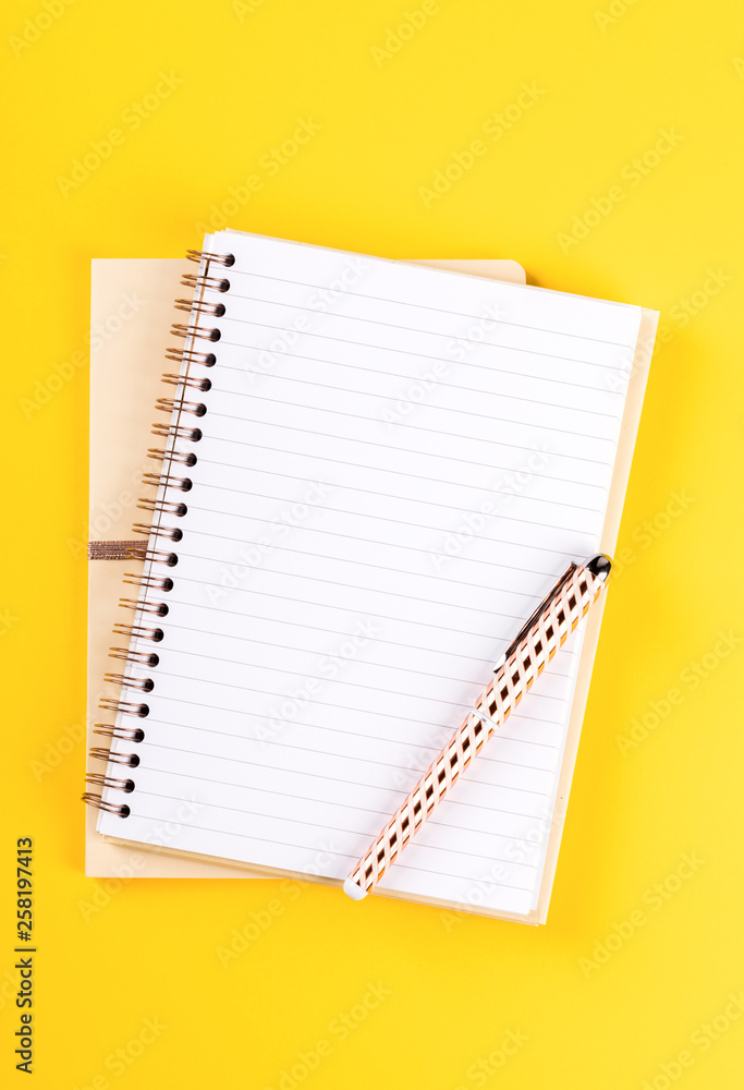 Notebook, and pen on a bright yellow background.Accessories office concept.Business Idea. Time to school.Top View.Flat Lay. Copy space for Text. Notebook, and pen on a bright yellow background.Accessories office concept.Business Idea. Time to school.Top View.Flat Lay. Copy space for Text.