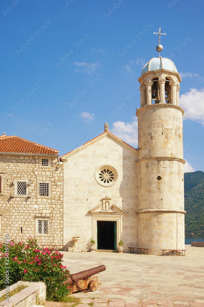 Religious architecture. View of ancient Church of Our Lady of the Rocks ( Gospa od Skrpjela ) on sunny summer day. Montenegro, Bay of Kotor