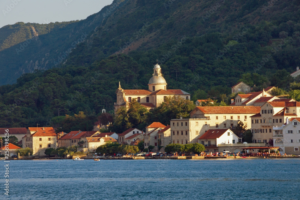 Beautiful Mediterranean landscape. Montenegro, Adriatic Sea, Bay of Kotor.  View of ancient town of Prcanj and Birth of Our Lady church on sunny summer day