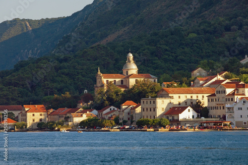 Beautiful Mediterranean landscape. Montenegro, Adriatic Sea, Bay of Kotor. View of ancient town of Prcanj and Birth of Our Lady church on sunny summer day