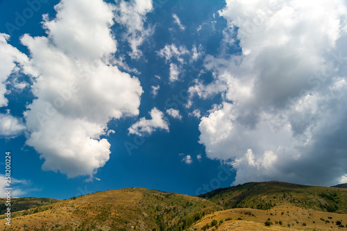 Spring time panoramic landscape from Old mountain, Bulgaria. Blue sky with white puffy clouds