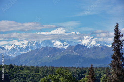 With its huge mountains and surrounded by a wonderful biodiversity lies the Denali National Park and Preserve. Touristic route and cloud sky. Landscape  fine art. Parks Hwy  Alaska  EUA  July 28  2018