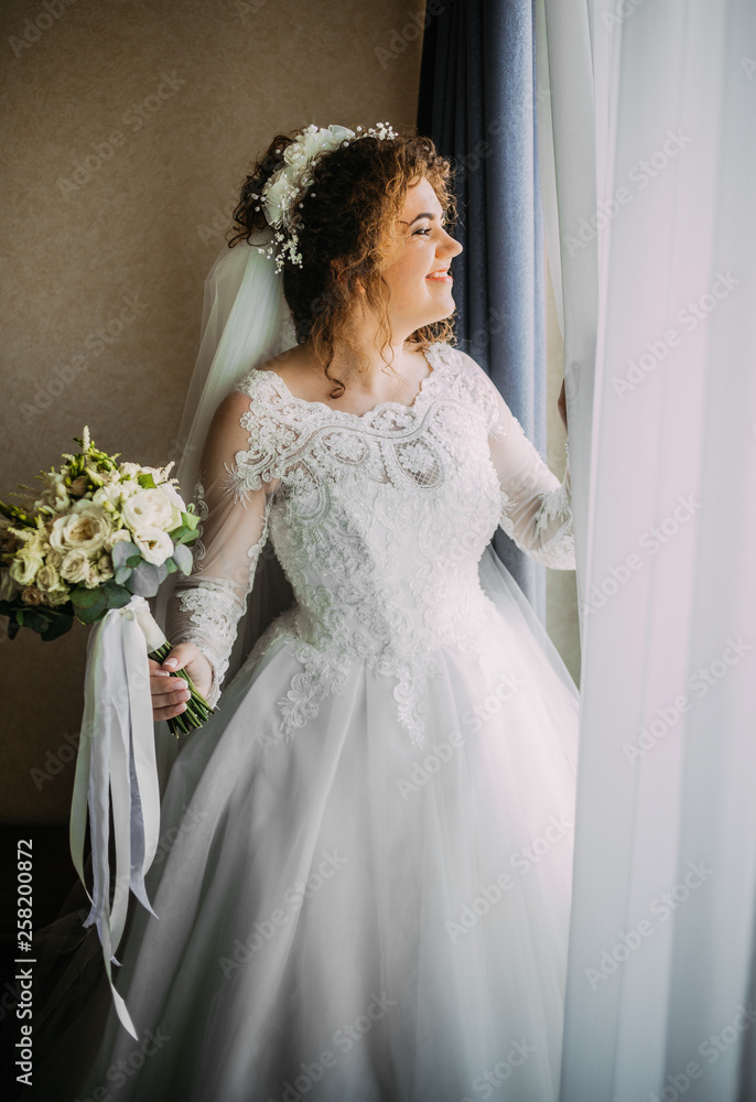 Cute bride looking at the window Cute bride looking at the window
