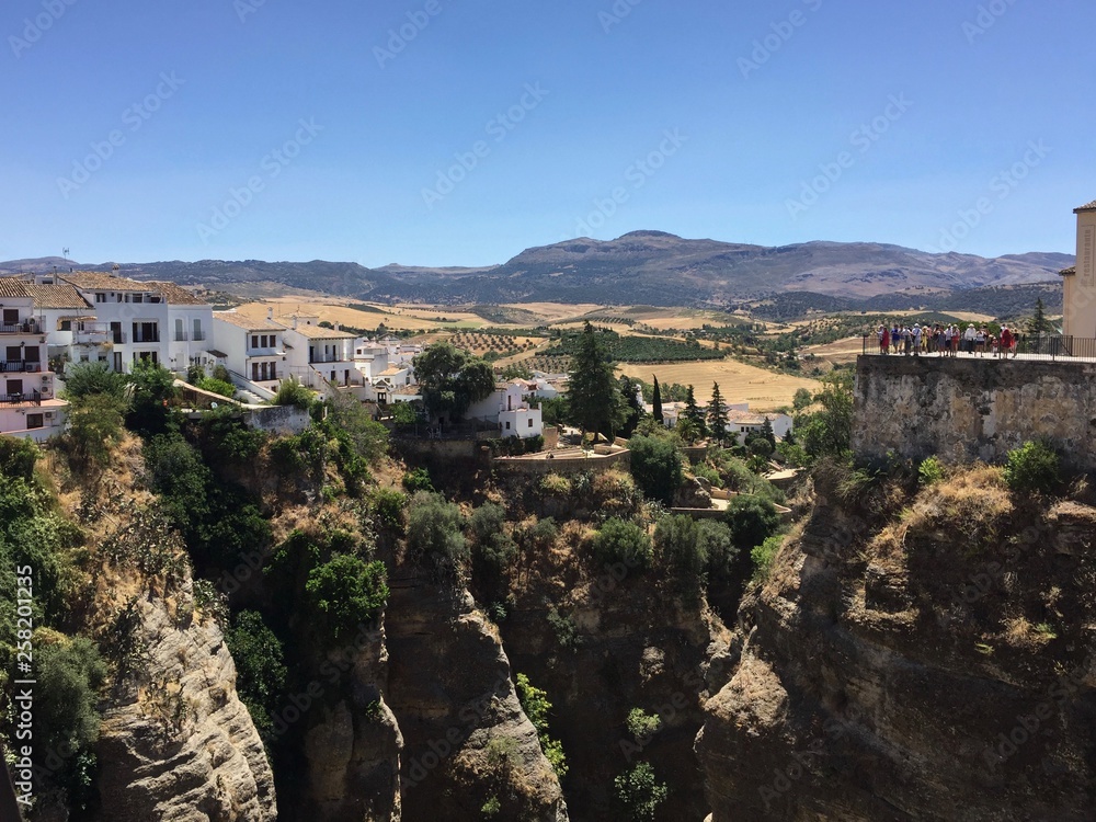 View from the Puente Nuevo in the city of Ronda in Andalusia, Spain. The Puente Nuevo is the newest and largest of three bridges that spanned the 120-metre-deep chasm that carries the Guadalevín River