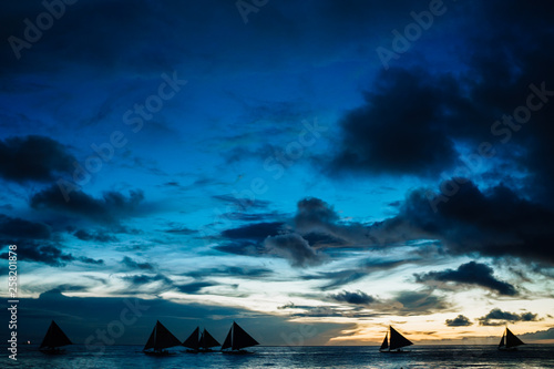 Sailboat in the sea and beautiful sunset at Boracay island, Philippines.