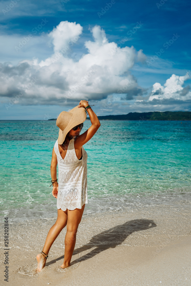 Girl on a tropical beach with hat. Philippines, Boracay