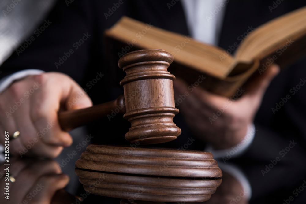 Judge, male judge in a courtroom striking the gavel
