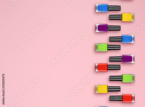 Flat lay color bottle with nail polish on pink background. top view. Flat lay
