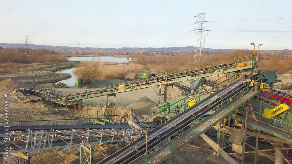 Elements of equipment for the extraction and sorting of rubble. Production of construction materials. Metal construction for working with stone and rocks. Slag of gravel under the conveyor belt Elements of equipment for the extraction and sorting of rubble. Production of construction materials. Metal construction for working with stone and rocks. Slag of gravel under the conveyor belt