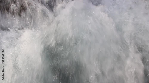 Closeup of a mountain river with rapids and stones. Rough river flow.
