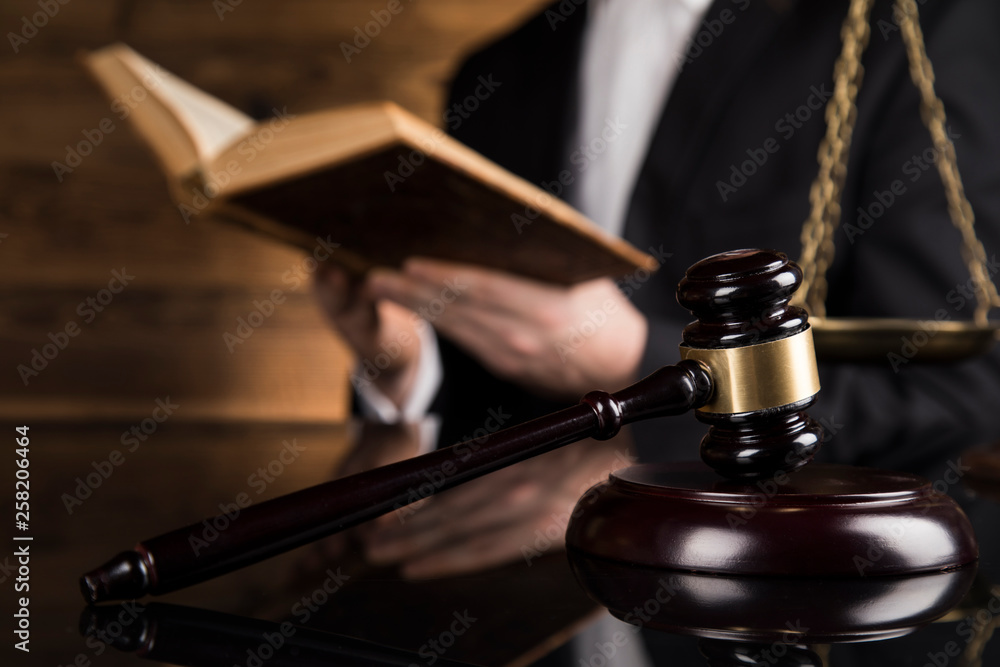 Judge, male judge in a courtroom striking the gavel Judge, male judge in a courtroom striking the gavel