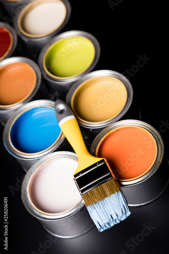 Tin cans with paint and brushes
