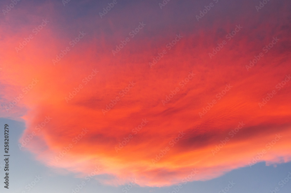 Reddish clouds at sunset over mountains