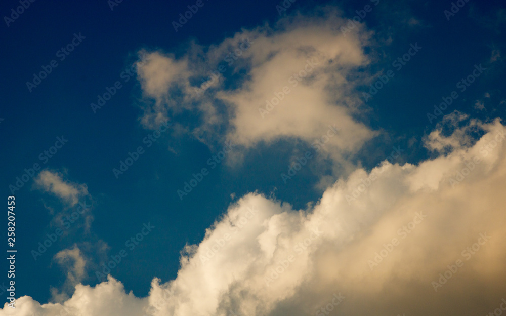Fototapeta premium Blue sky with clouds forming drawing in the sky, natural nature