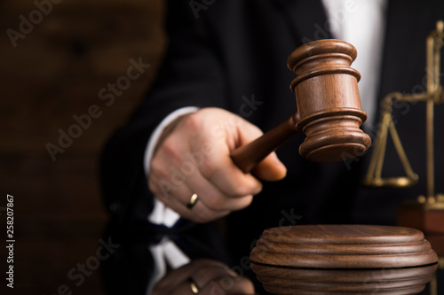 Judge, male judge in a courtroom striking the gavel