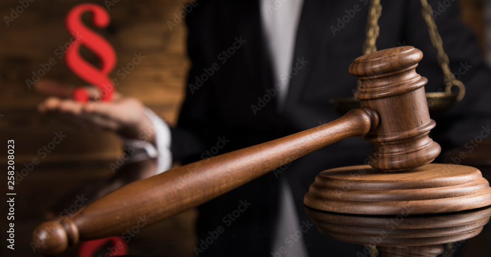 Judge, male judge in a courtroom striking the gavel