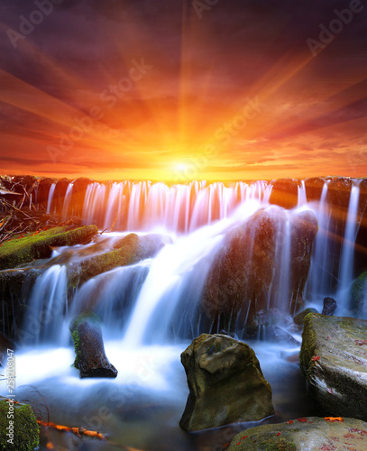 Fototapeta Naklejka Na Ścianę i Meble -  waterfall on sunset background