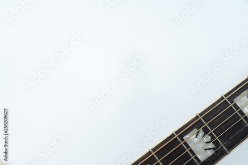 Close-up. Acoustic guitar neck in the right-down corner on white background