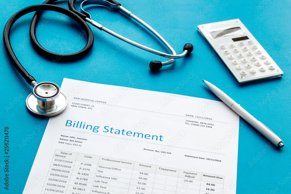 medical treatment bill, calculator and phonendoscope on blue background medical treatment bill, calculator and phonendoscope on blue background