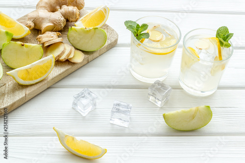 Fototapeta Naklejka Na Ścianę i Meble -  healthy drinks with apple and lemon for summer on white wooden background