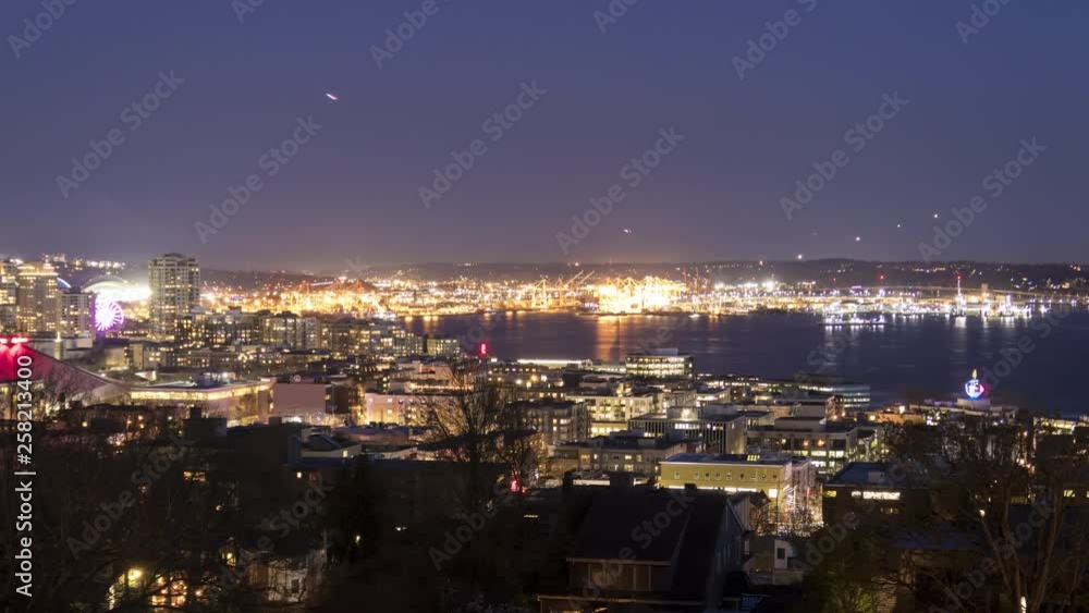 4K Time Lapse movie of Harbor Island in the Elliott Bay and airplanes taking off and coming in to land nonstop from Seattle airport at night.