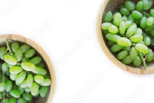 Wallpaper Mural Two wooden bowls of green grapes on white background. Green grapes Kish Mish. Top view. Symmetry composition. Torontodigital.ca