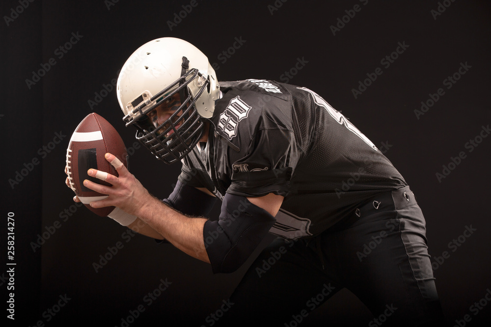 Bearded American football player in helmet, portrait. Bearded American football player in helmet, portrait.