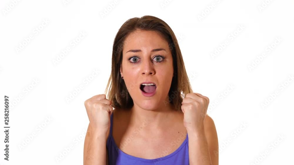 4K movie. Happy excited young beautiful woman celebrating victory and winning making surprised and cheerful gestures over white background. In luck and celebration concept. 4K movie. Happy excited young beautiful woman celebrating victory and winning making surprised and cheerful gestures over white background. In luck and celebration concept.