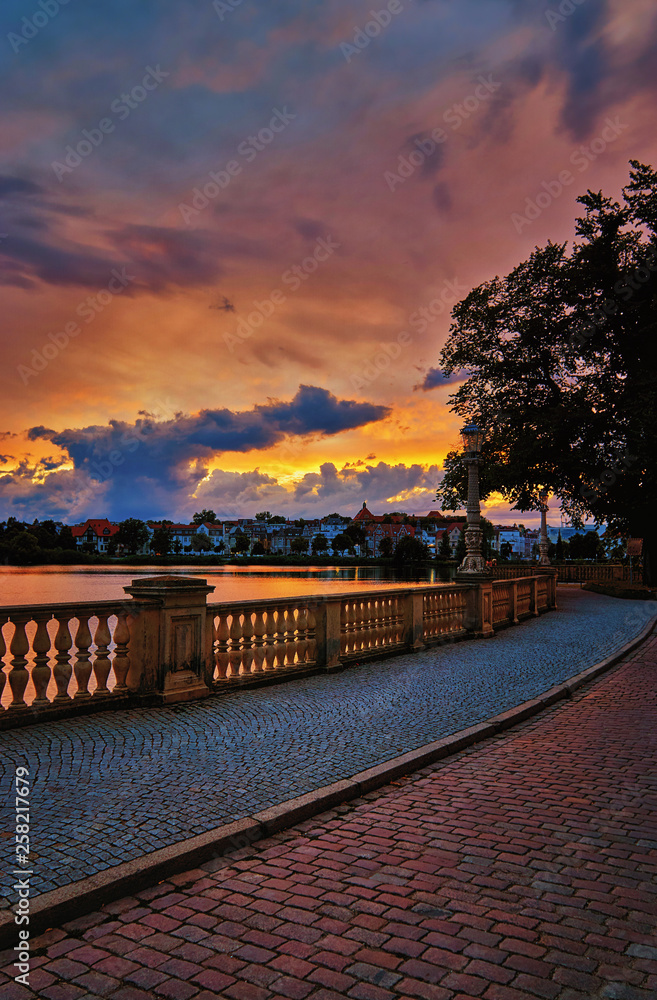 On the castle bridge in Schwerin with sunset in the background. Mecklenburg-Vorpommern, Pomerania, Germany