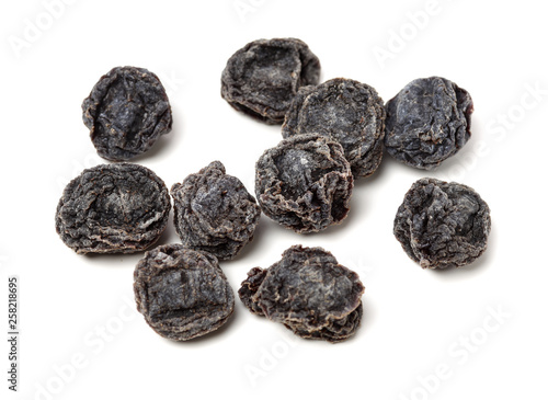 Dried black plums isolated on white background