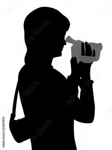 Woman with video camera, looking through viewfinder