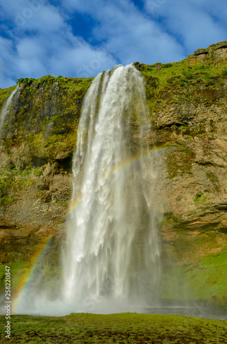 Close up profile view of iceland waterfall seljalandsfoss with rainbow  © JMP Traveler