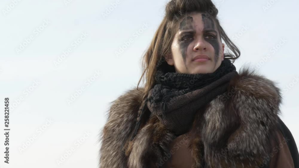 Female Nordic warrior turning around and drawing axe Female Nordic warrior turning around and drawing axe